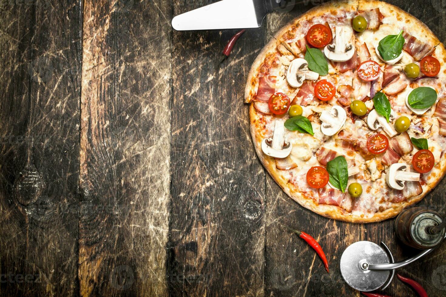 Fresh pizza. On wooden background photo