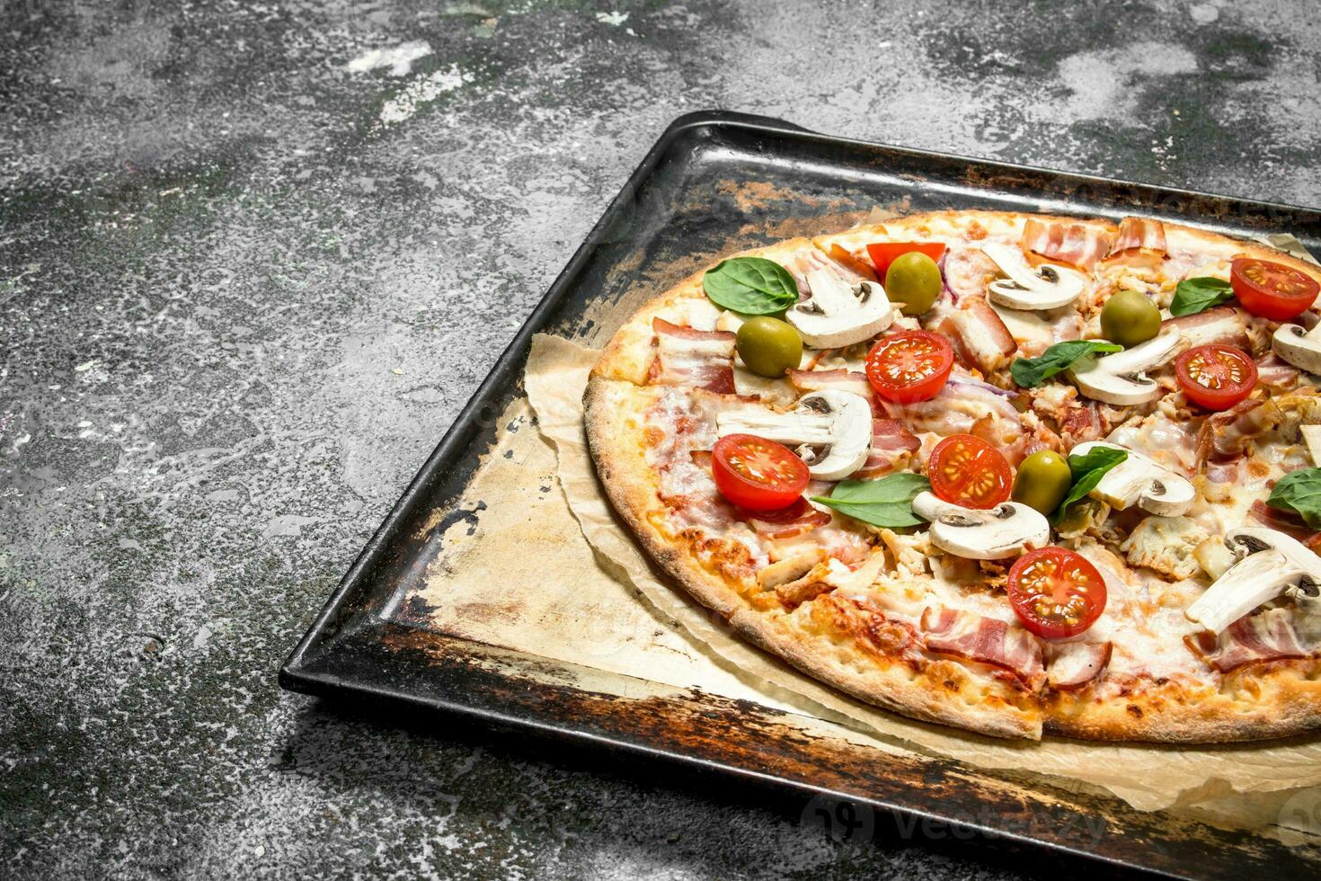 Fresh pizza on a baking sheet. photo