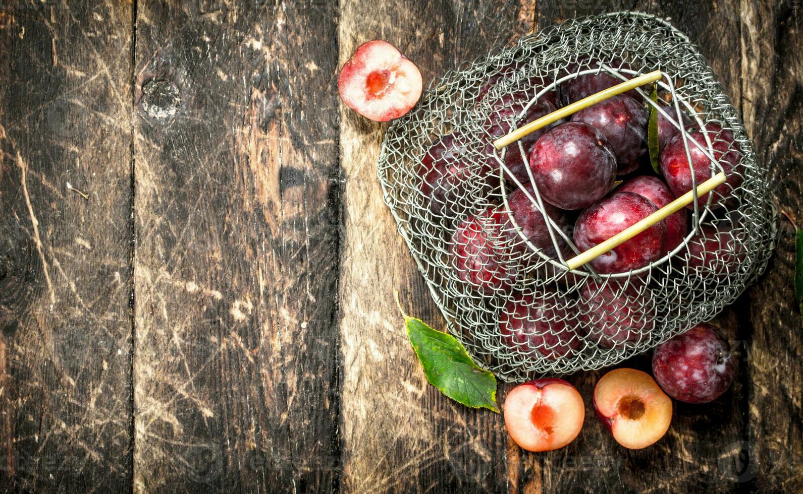 Fresh plums in a mesh bag. photo