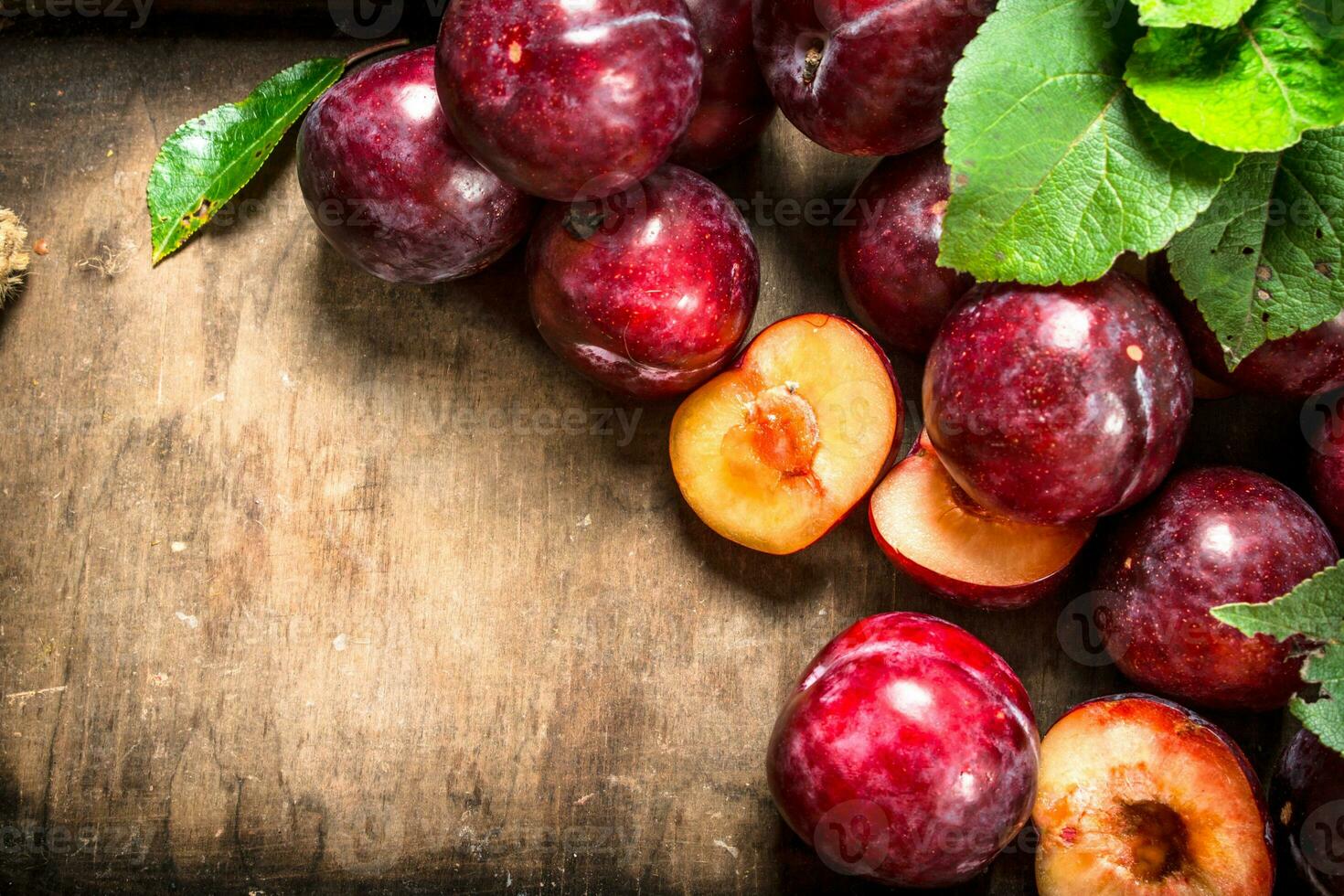Ripe plums in a wooden tray. photo