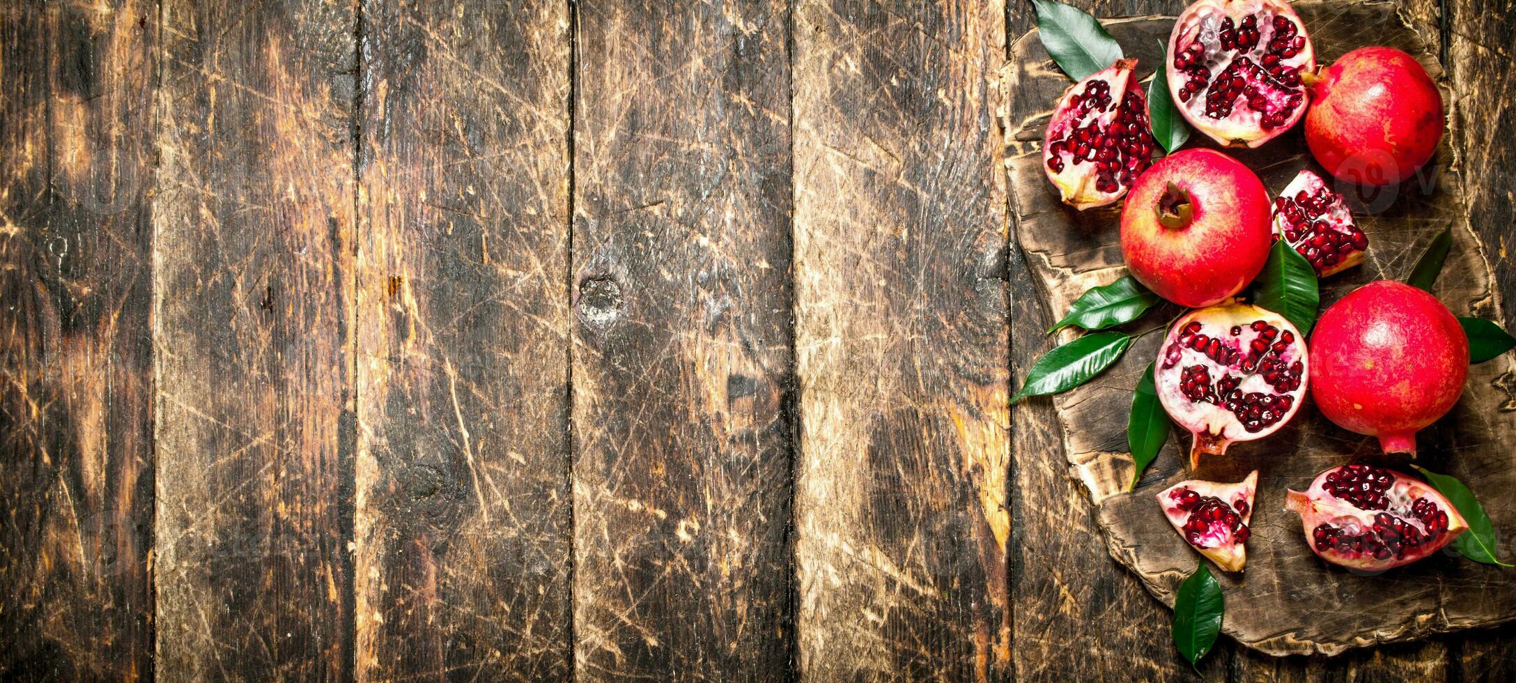 Ripe pomegranates on a cutting Board. photo