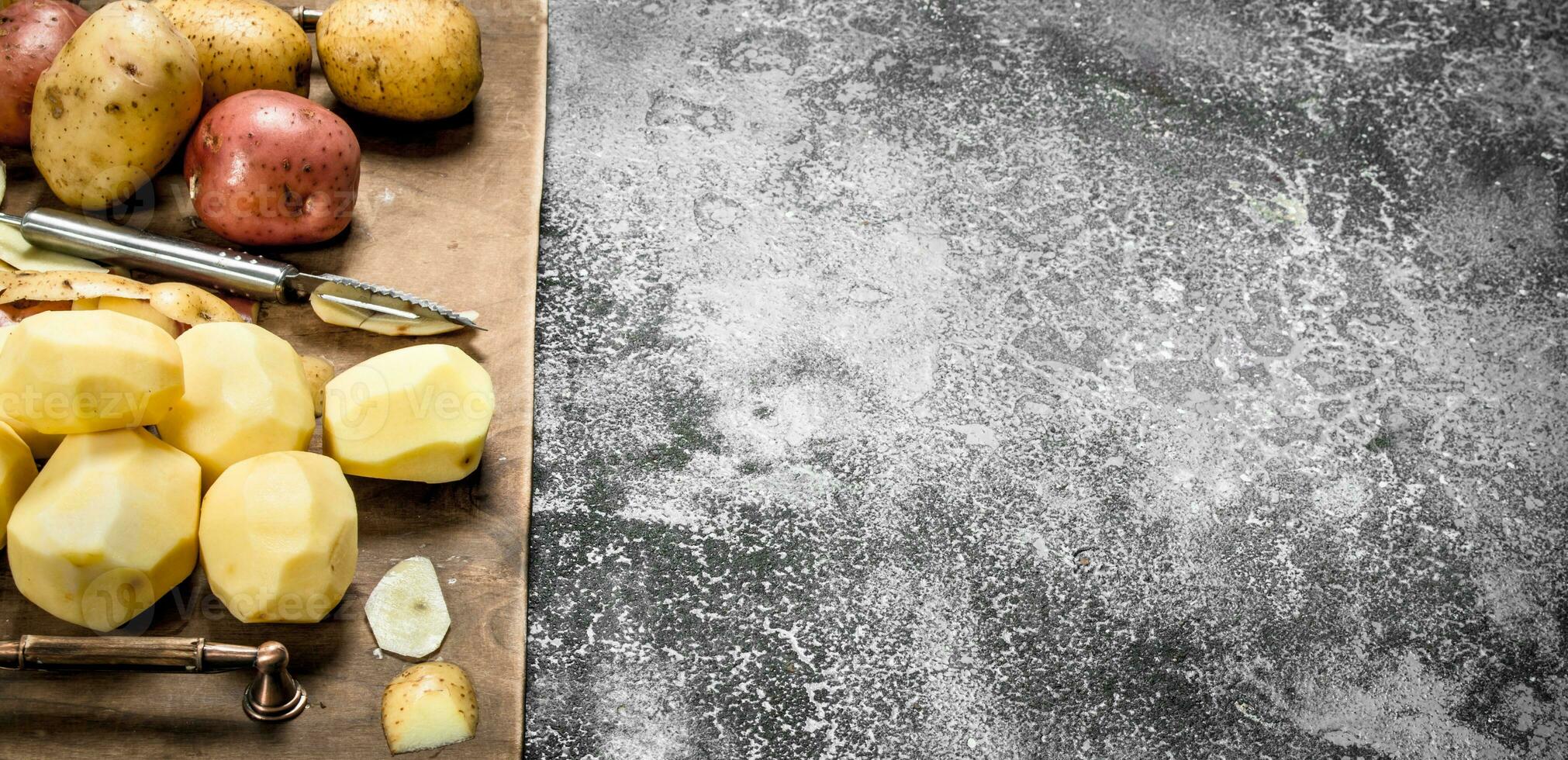 Fresh peeled potatoes in an old tray. photo