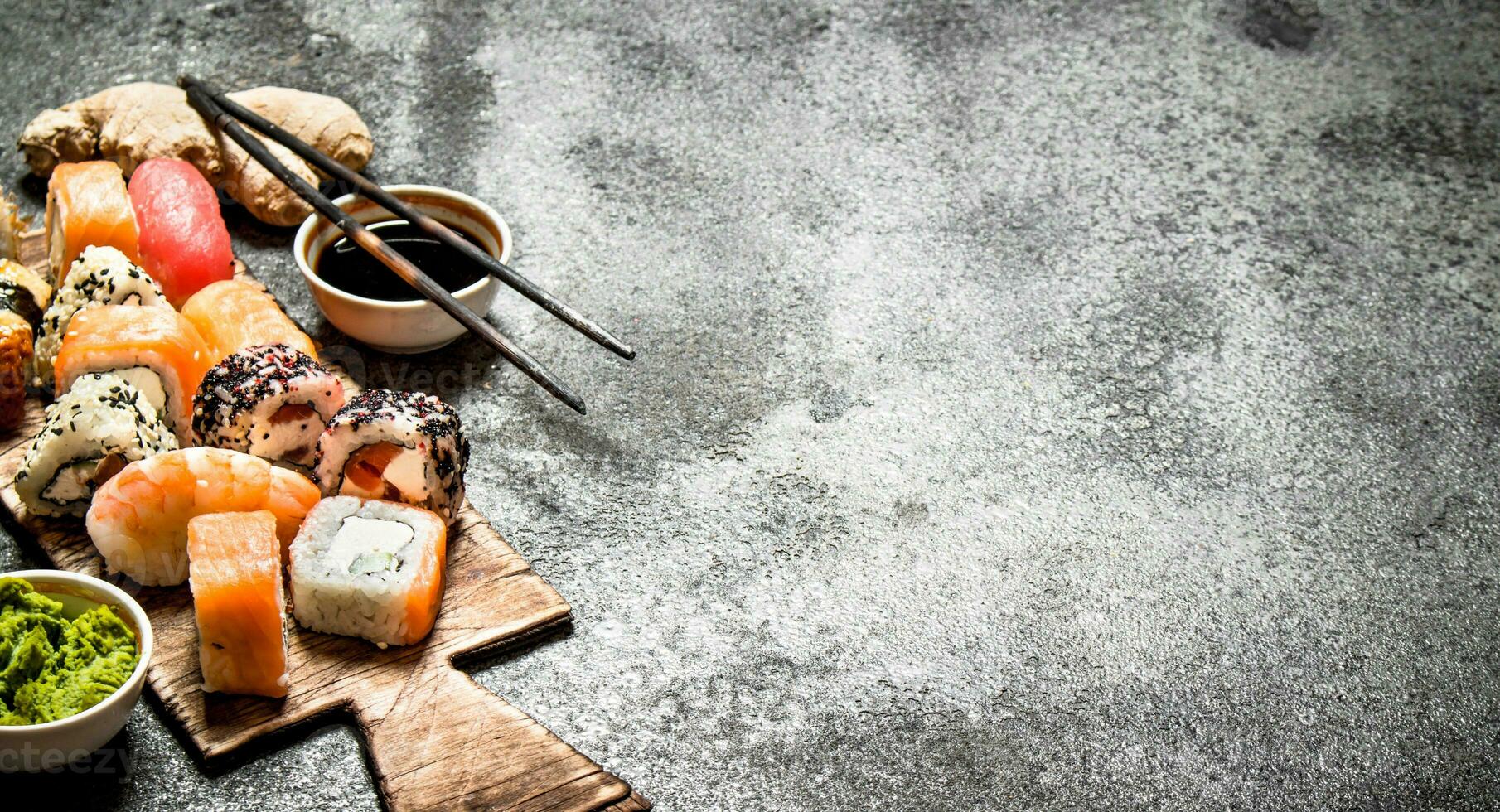 Japanese food. Fresh rolls with seafood and soy sauce. On rustic background. photo