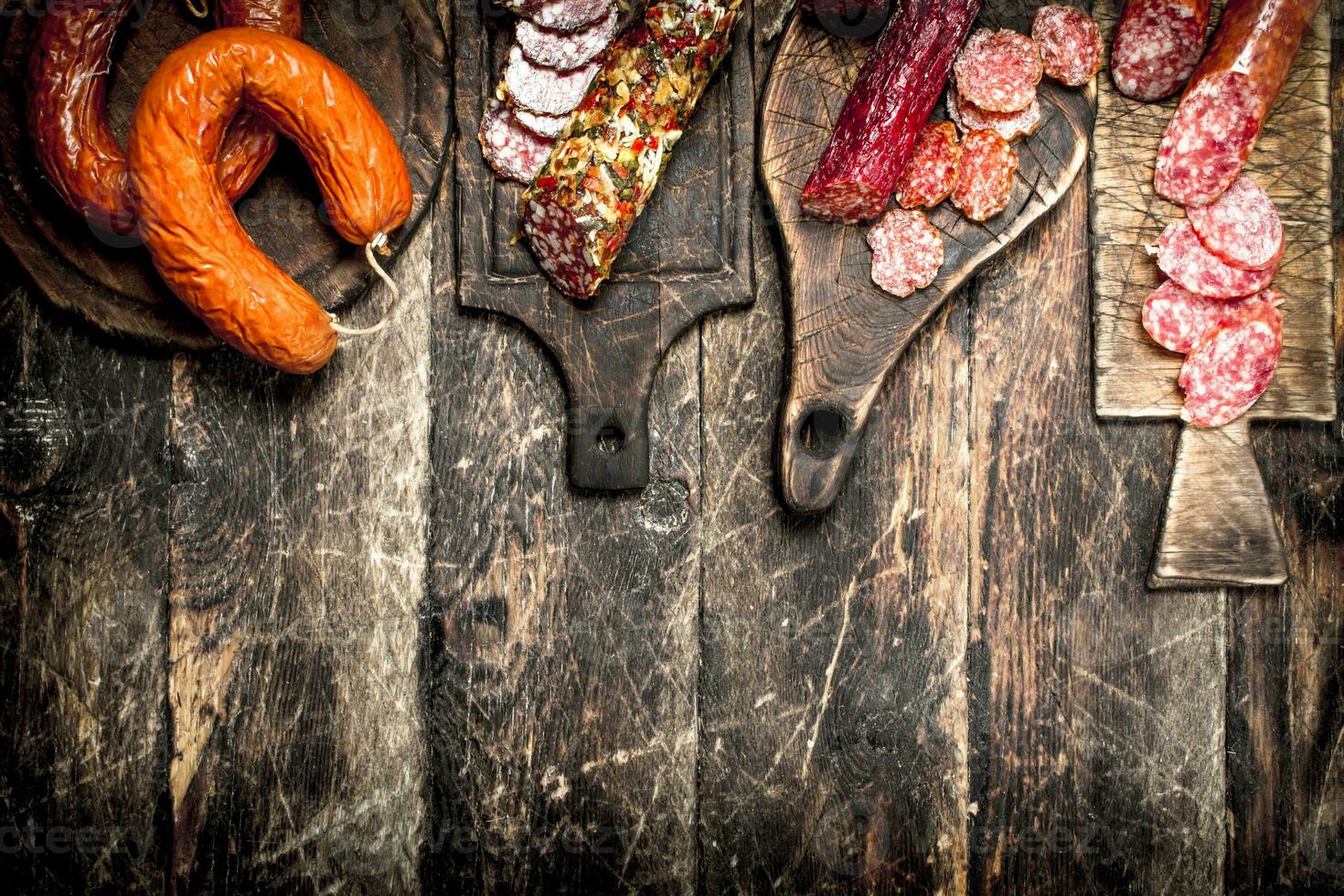 Different kinds of salami on the boards. photo