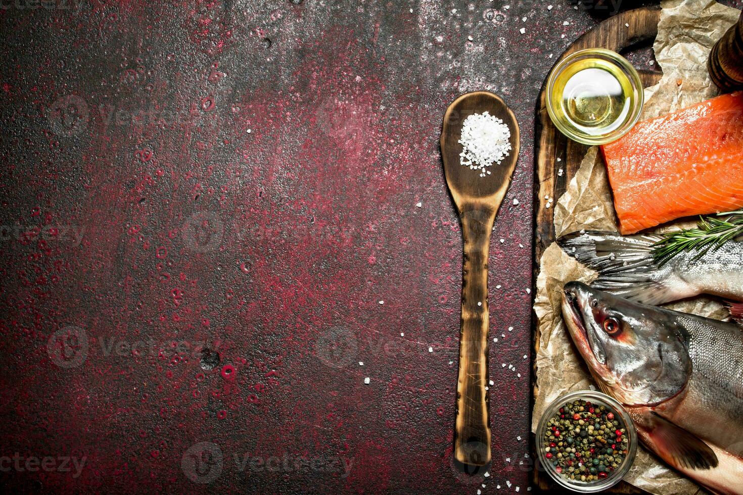 Fresh fish with a piece of fillet and spices. On rustic background. photo