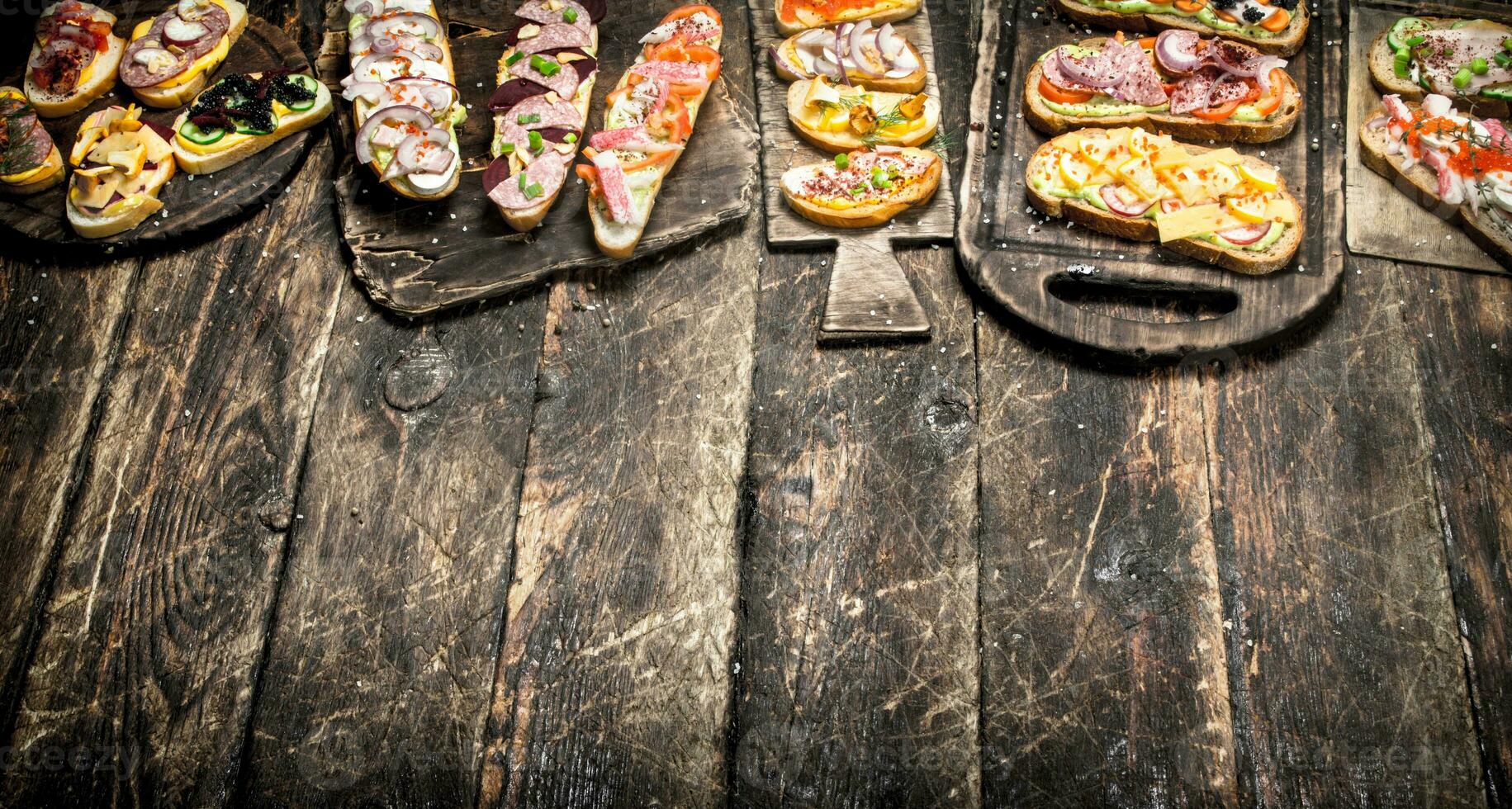 Various sandwiches with seafood, meat and vegetables. photo
