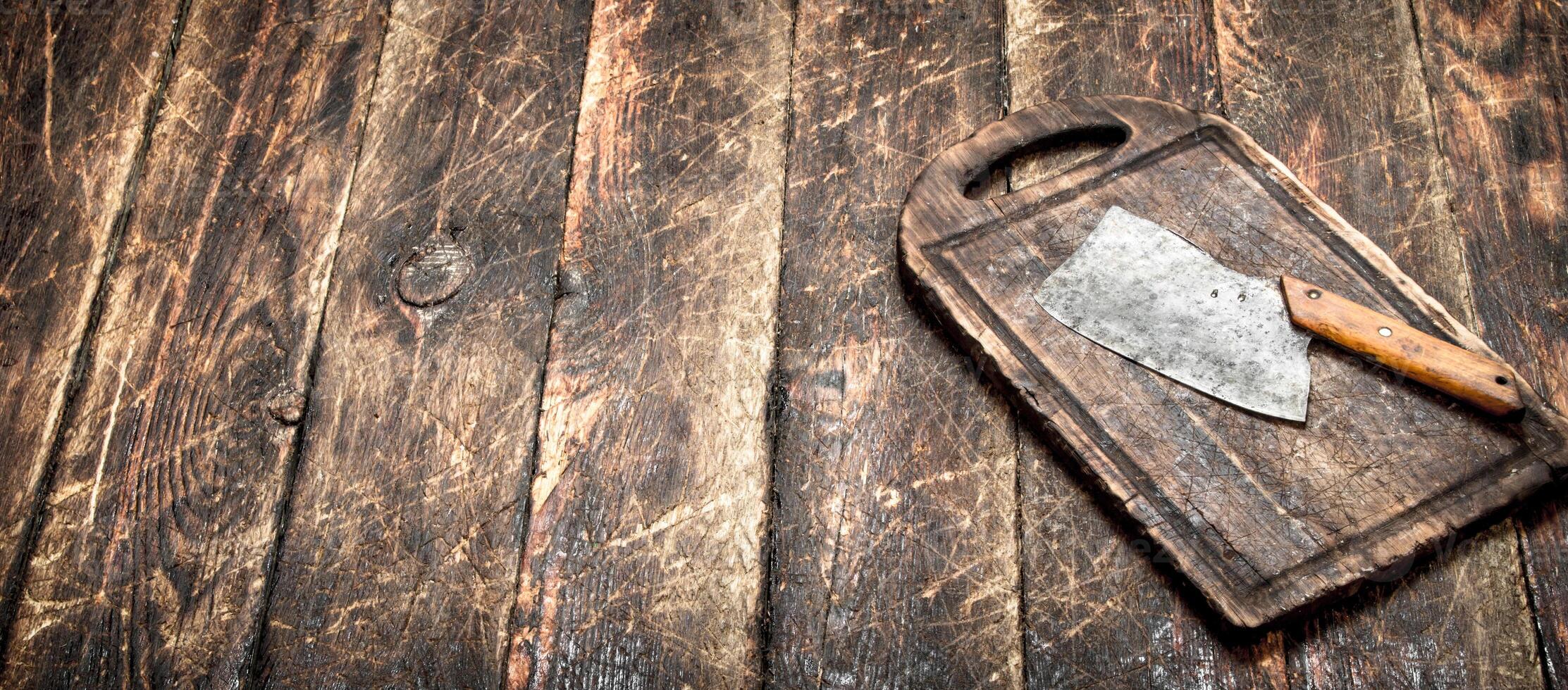 Serving background. Old hatchet on a chopping Board. photo