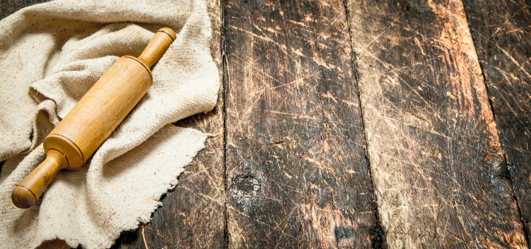 Serving background. Rolling pin the old fabric. photo