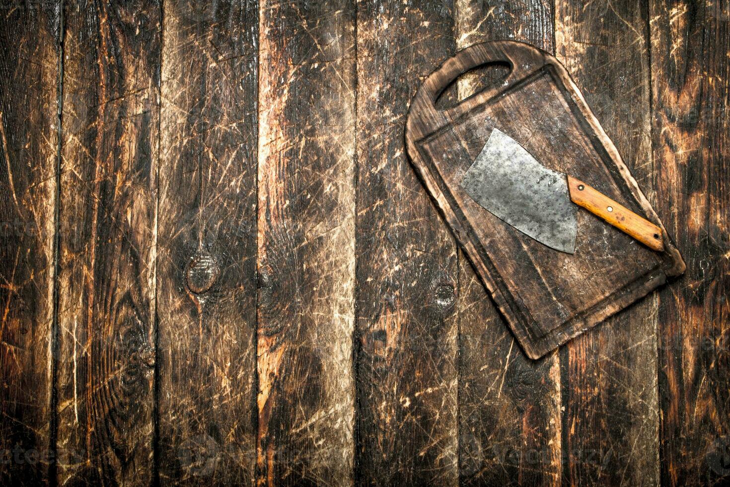 Serving background. Old hatchet on a chopping Board. photo
