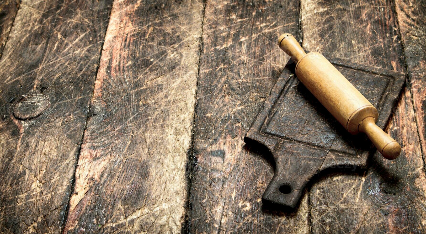 Serving background. Rolling pin on a cutting Board. photo