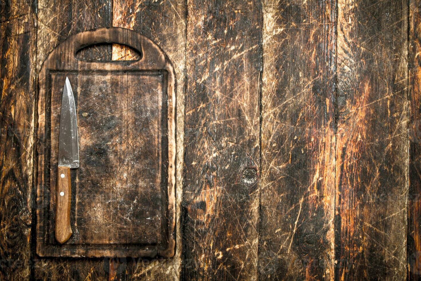 Serving background. Cutting Board with a knife. photo