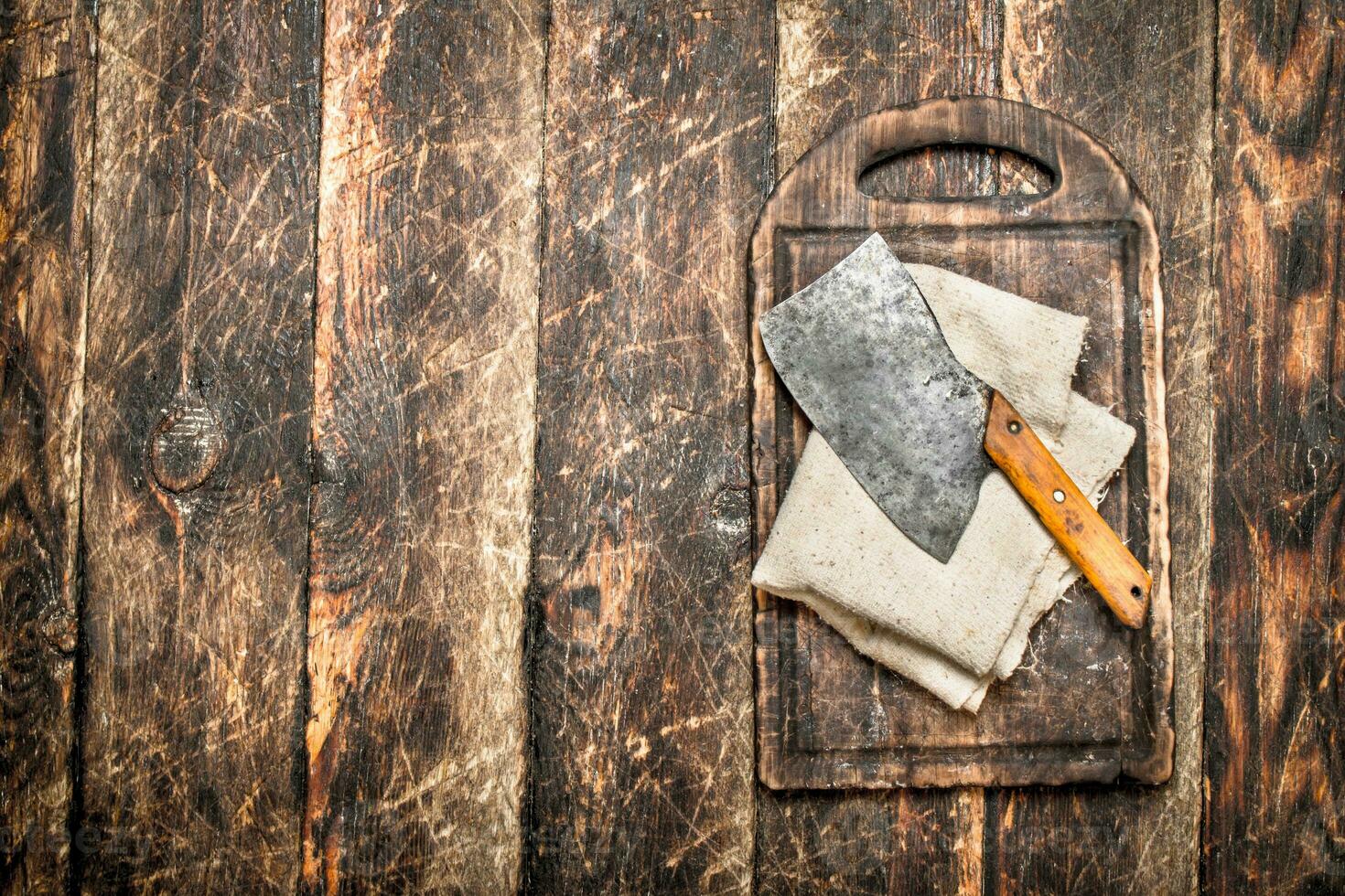 Serving background. Old hatchet on a chopping Board. photo