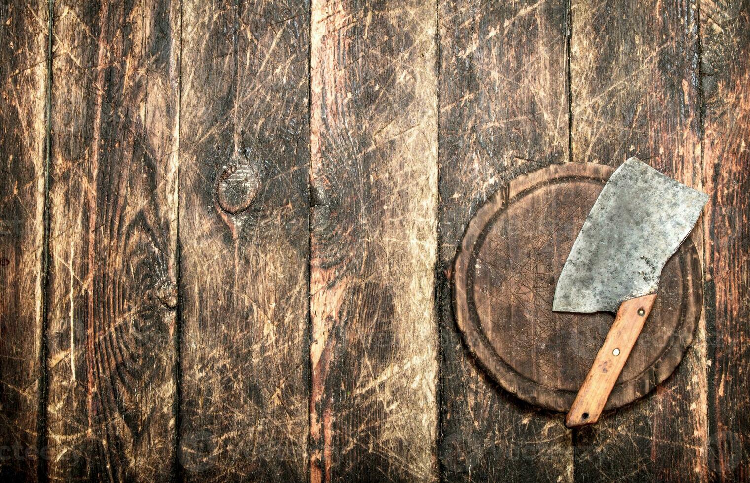 Serving background. Old hatchet on a chopping Board. photo