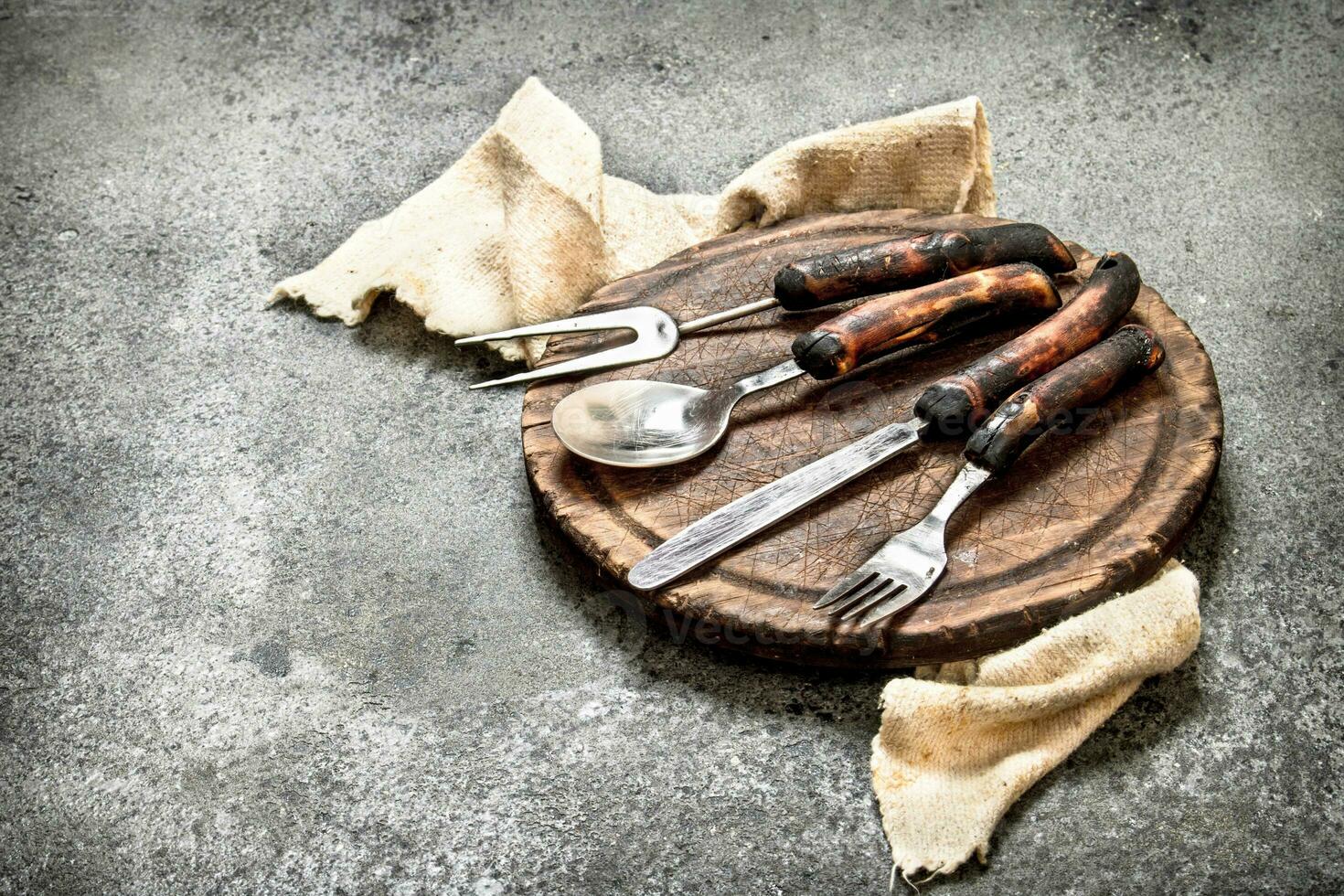 Serving background. Cutlery on the old Board. photo