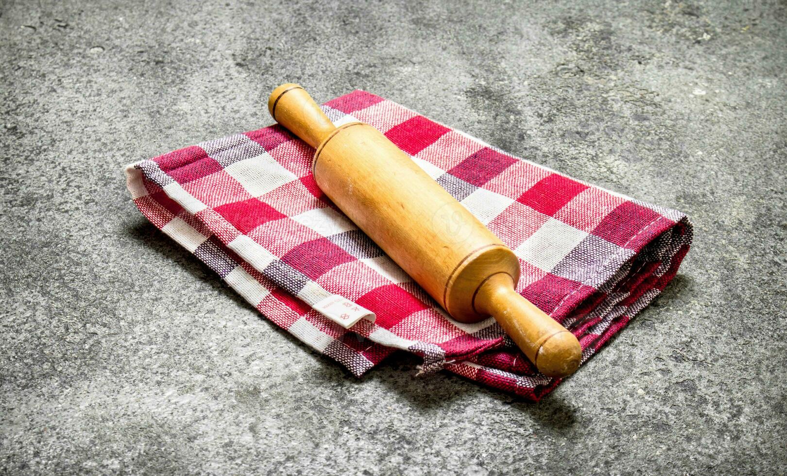 Serving background. Rolling pin on a napkin. photo