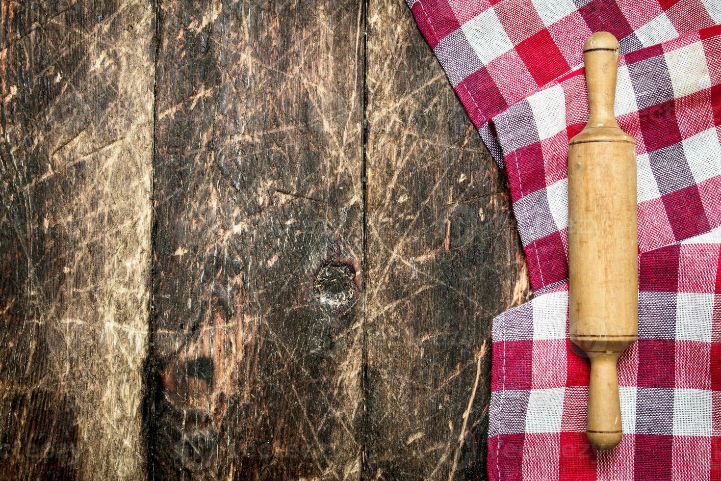 Serving background. Rolling pin with cloth. photo