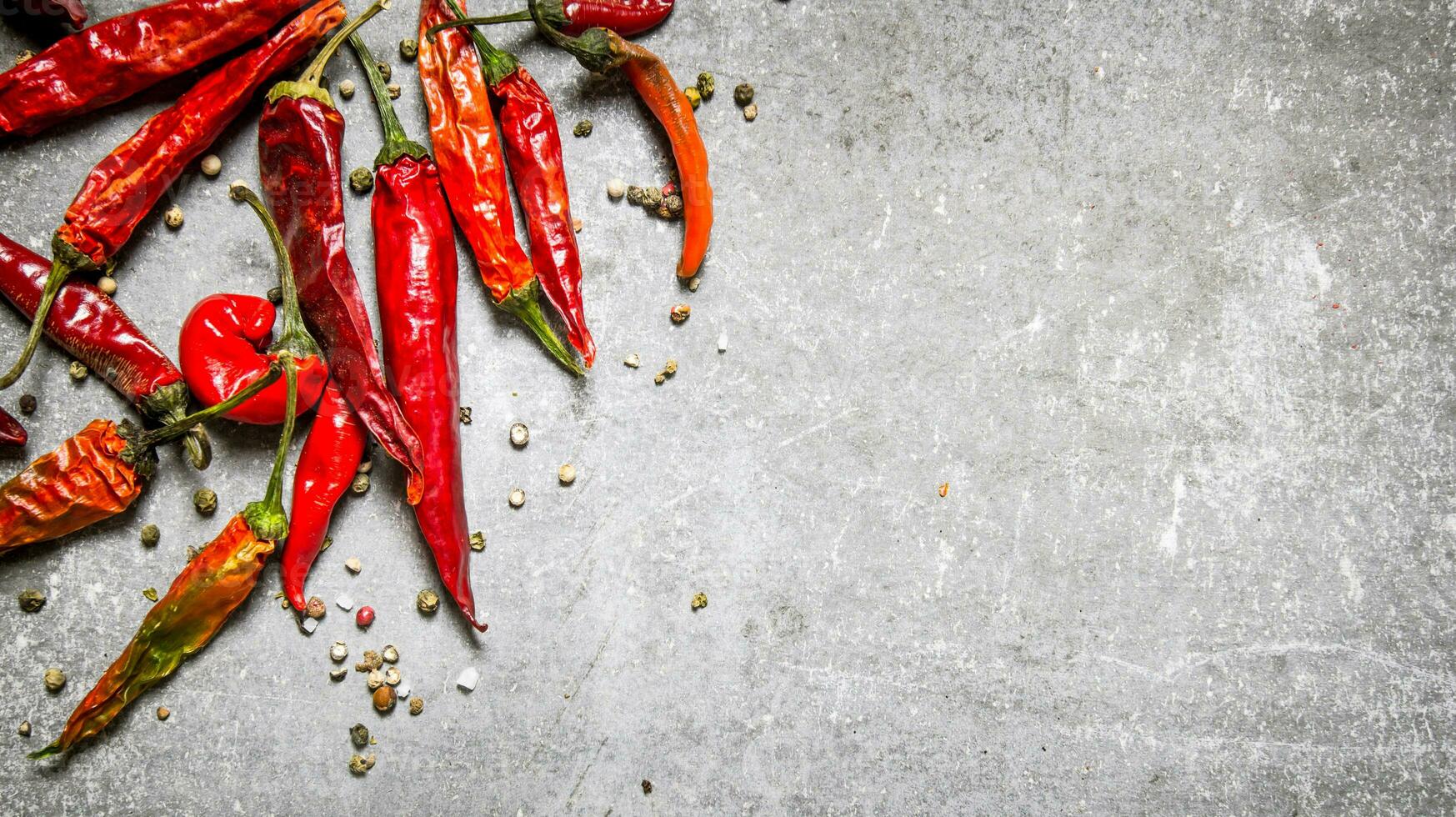 Red chili pepper dried. On stone background. photo