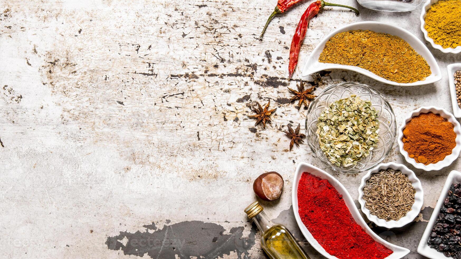 Large set of spices and herbs in the cups. photo