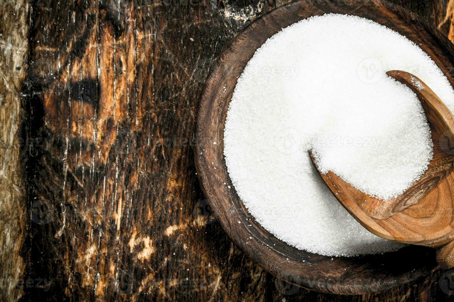 Sugar with a scoop in a bowl. photo