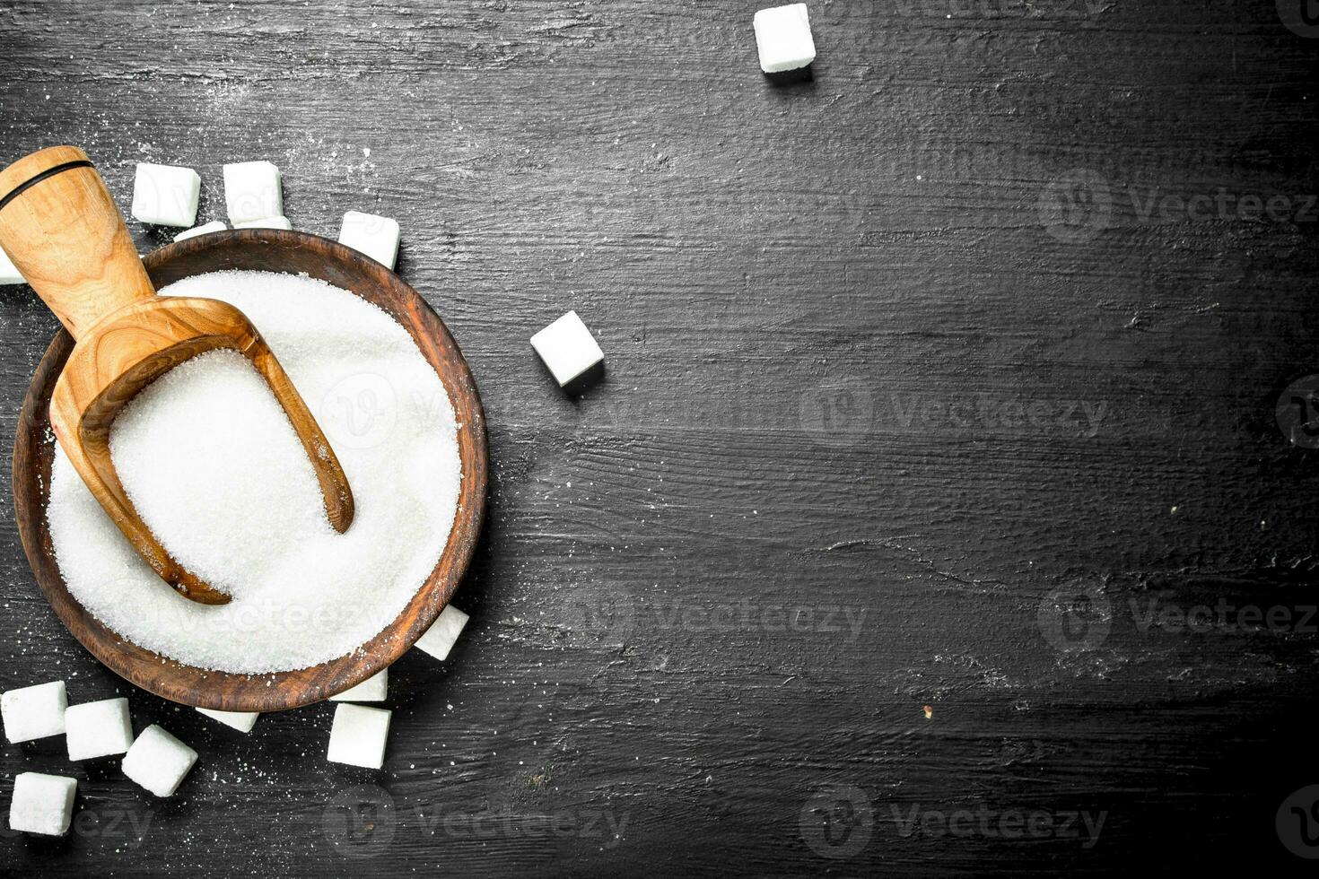 Sugar in a bowl with a scoop. photo