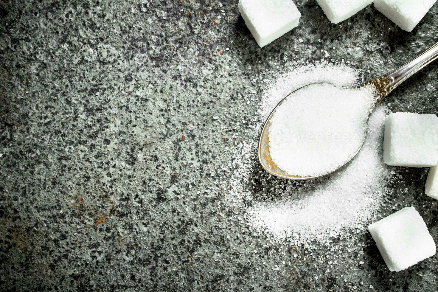 Sugar in a teaspoon. photo