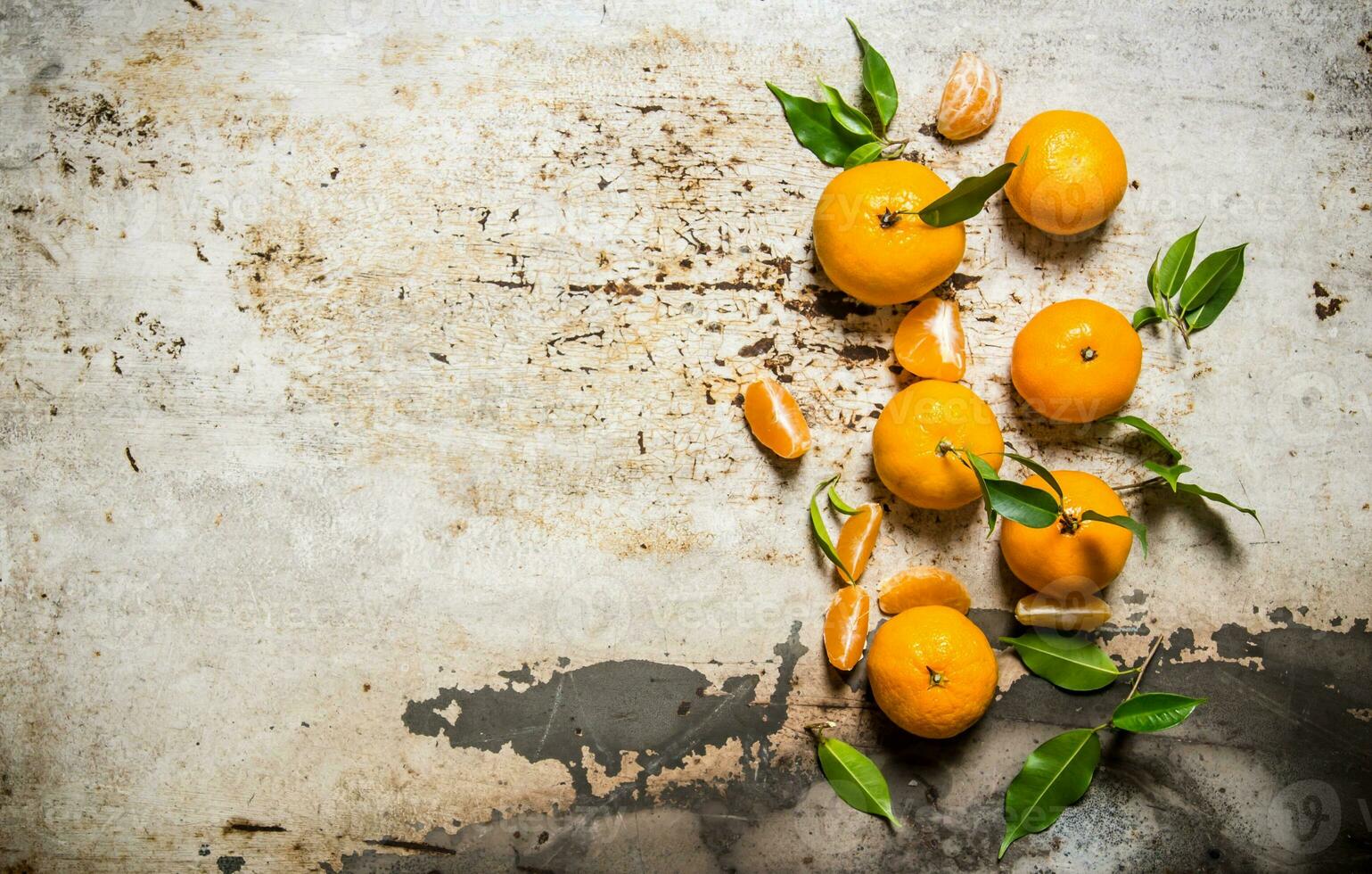 Fresh mandarins with leaves. On rustic background. photo