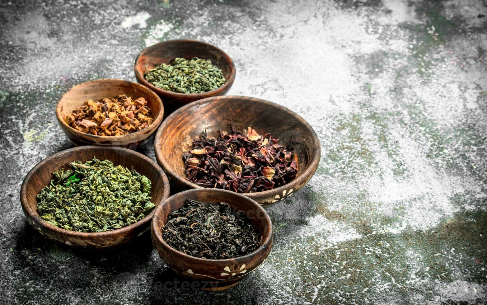 Different kinds of fragrant tea in bowls. photo