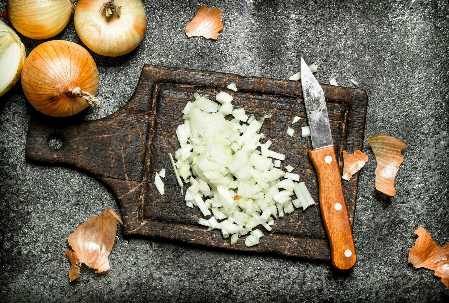 Fresh chopped onion on the old Board. On rustic background. photo