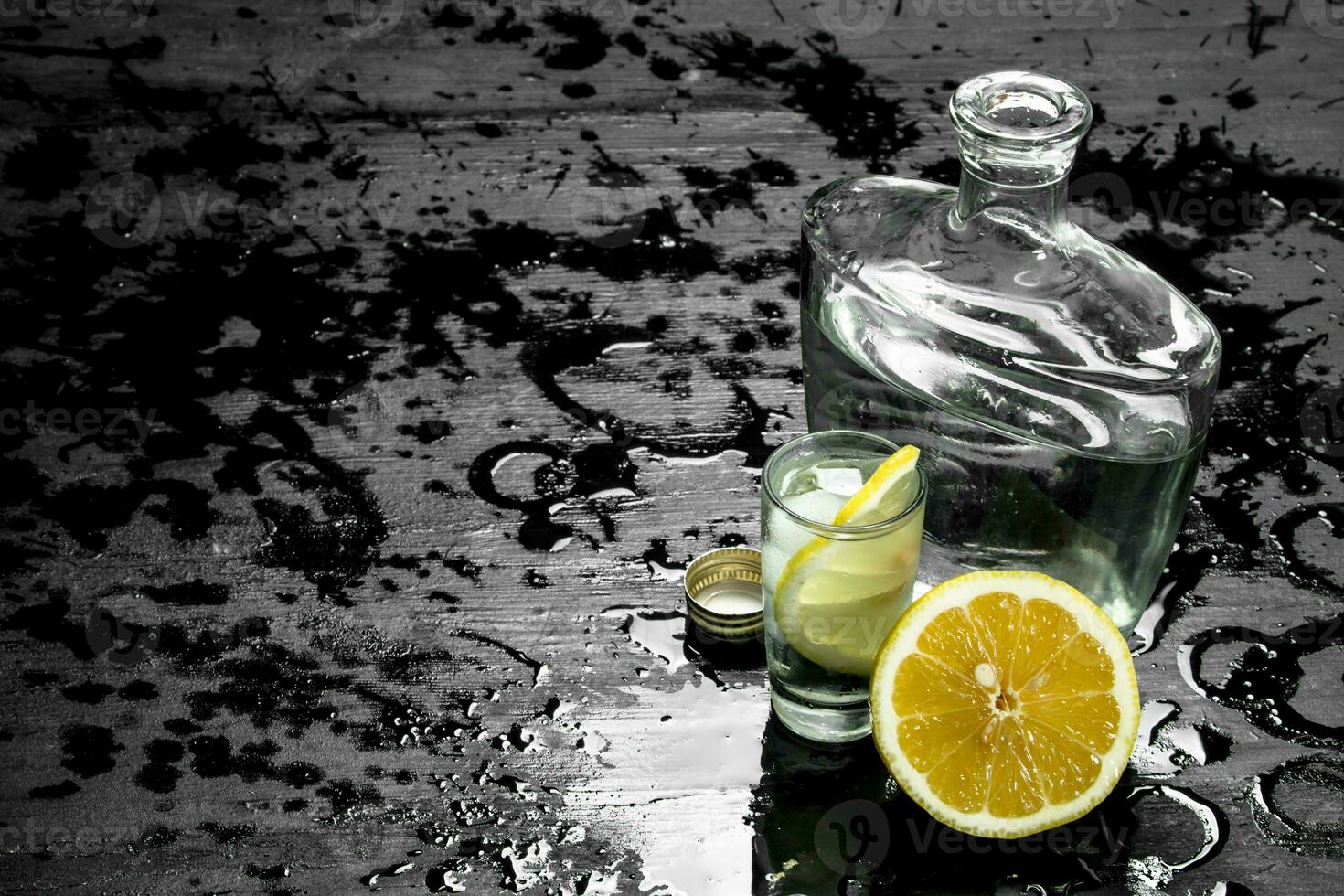 Vodka in glasses with lemon and ice. photo