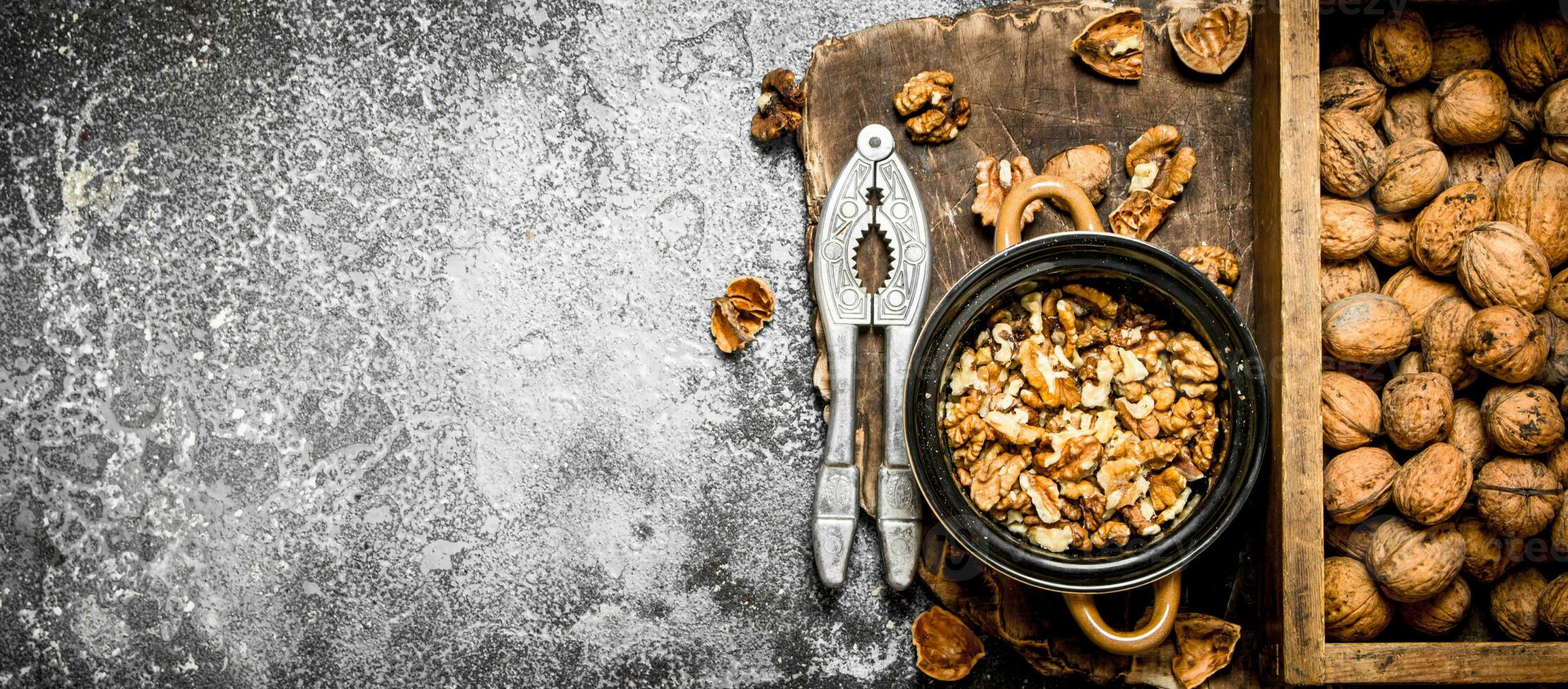 Shelled walnuts in bowl with Nutcracker photo