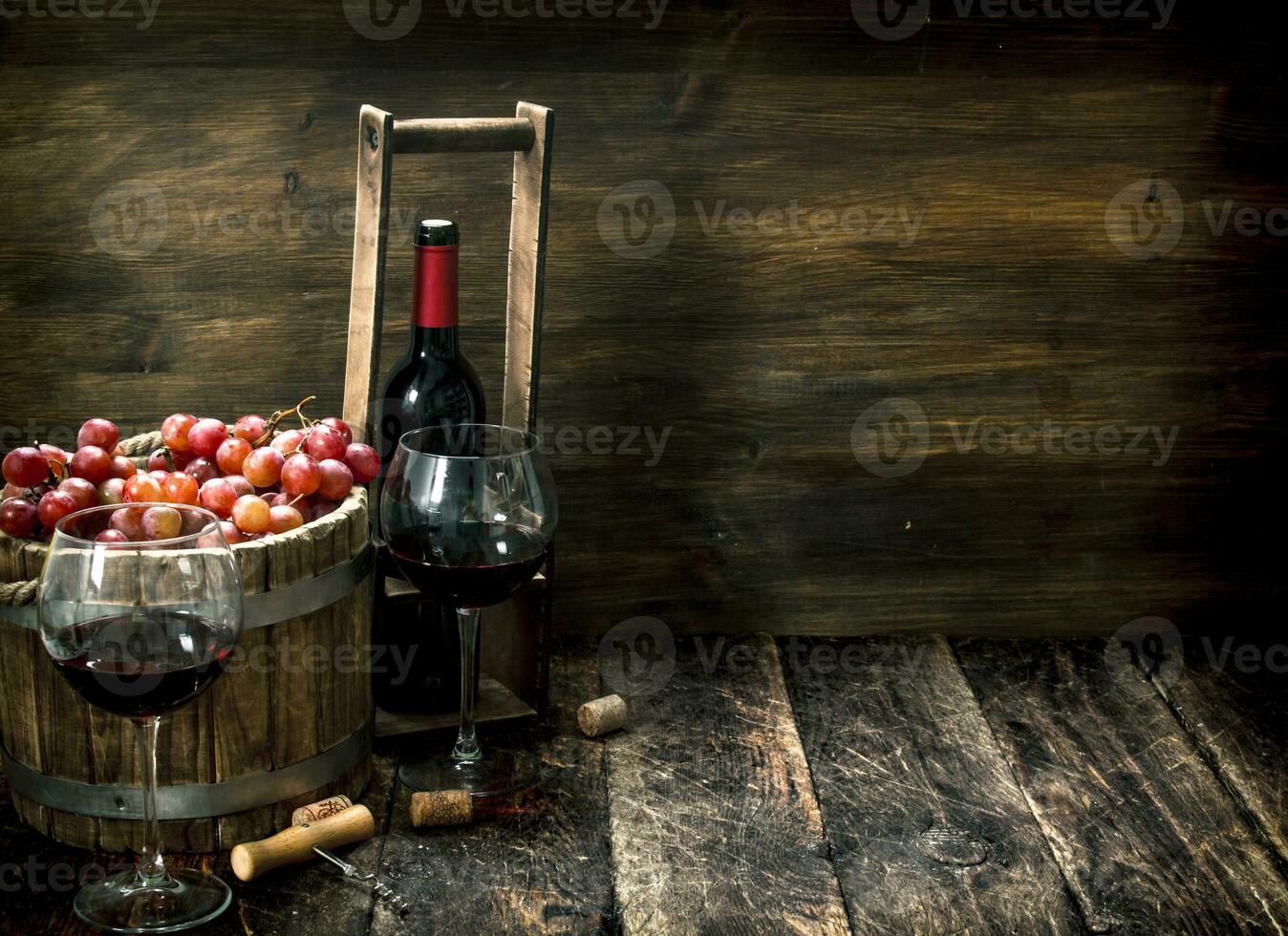 Red wine with a bucket of grapes. photo