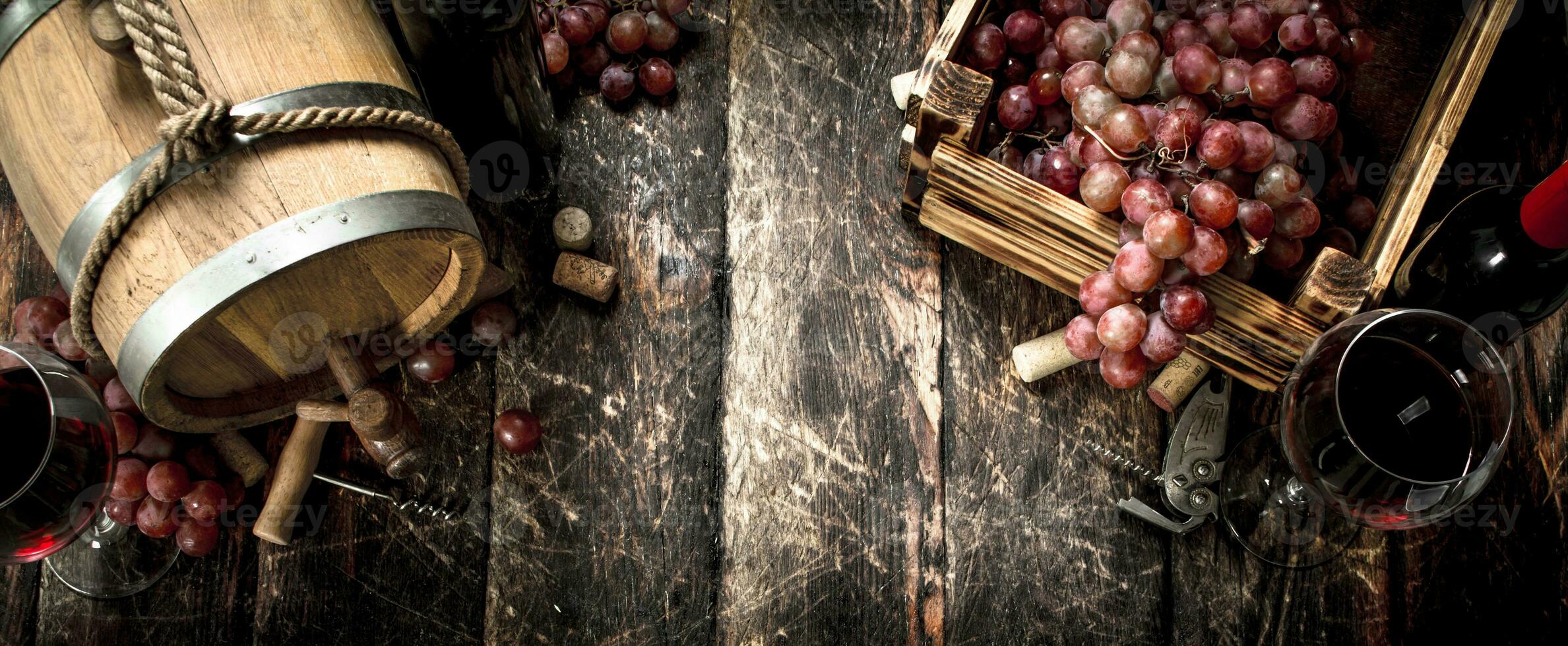 Wine background. A barrel with red wine and freshly grapes. photo