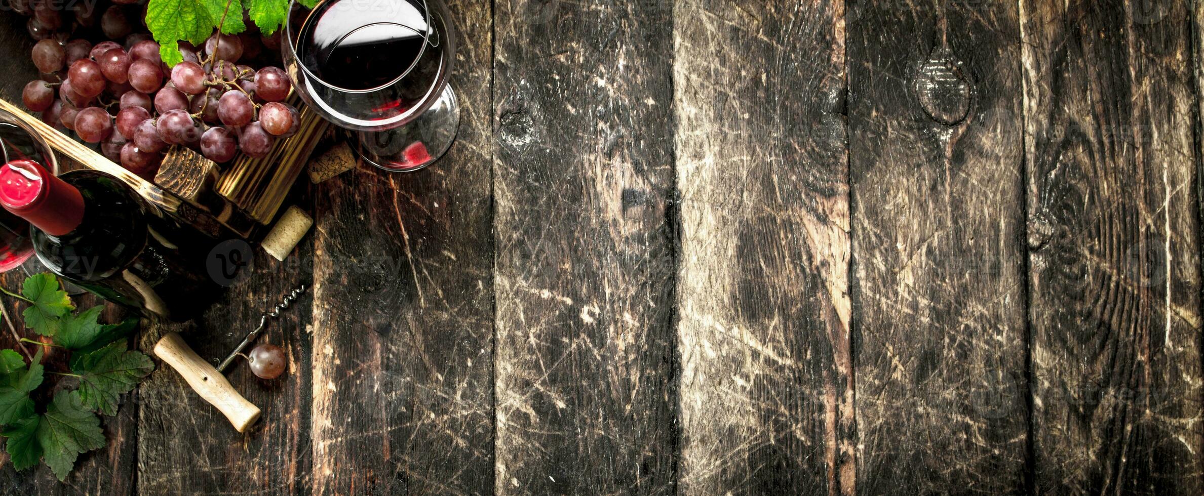 Wine background. Red wine with a box of grapes. photo