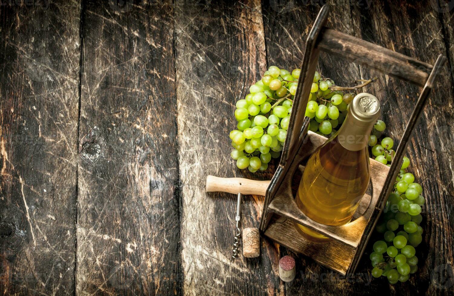 Wine background. White wine on a stand with branches of fresh grapes. photo