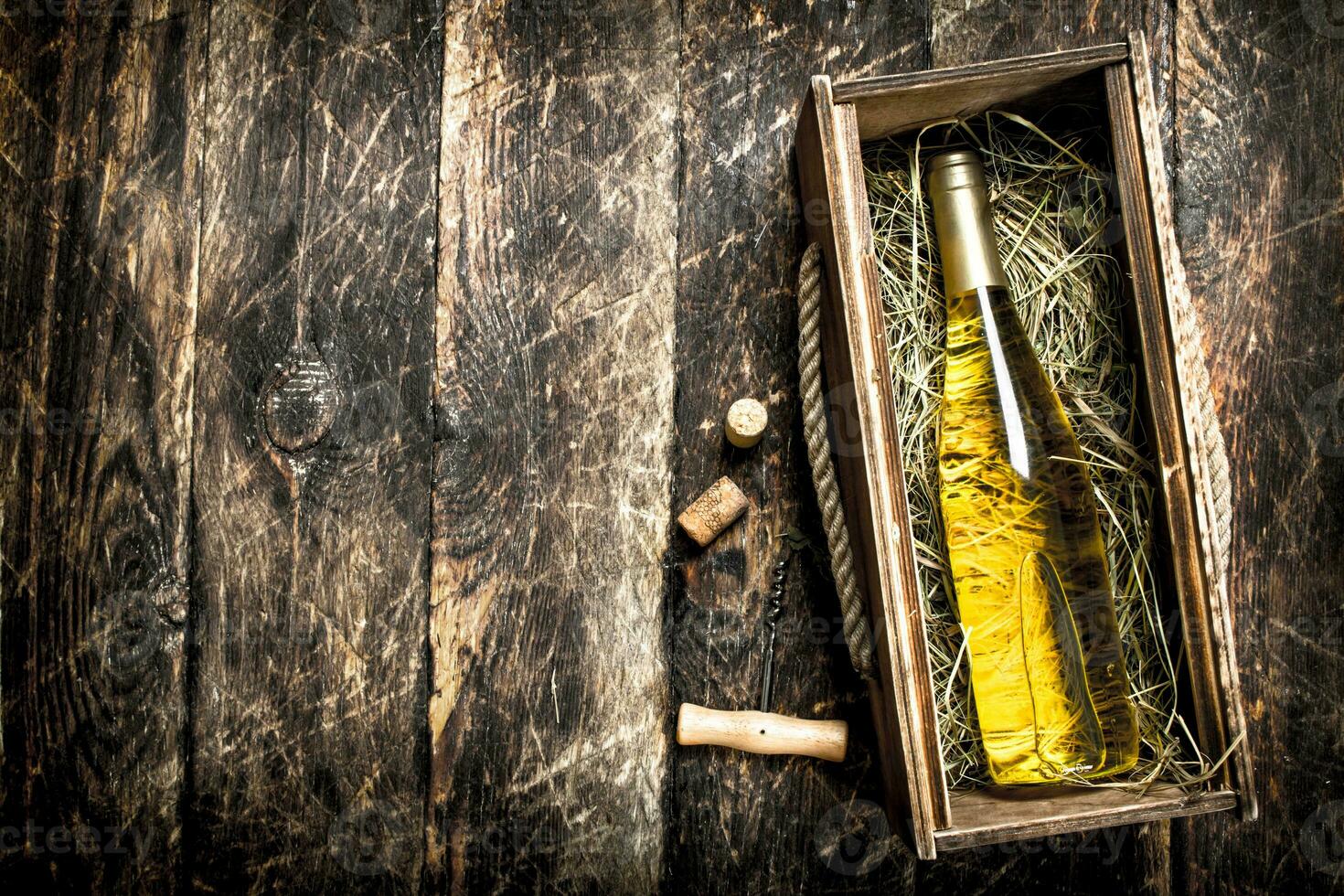bottle of white wine in an old box. photo
