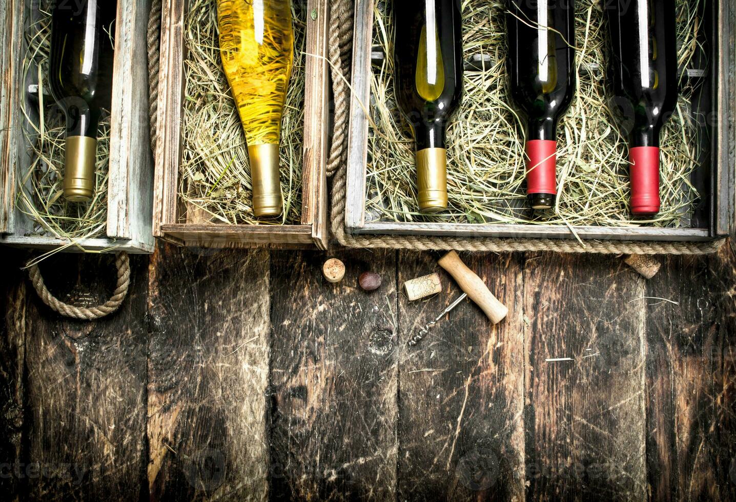 Wine background. Bottles of red and white wine in old boxes. photo