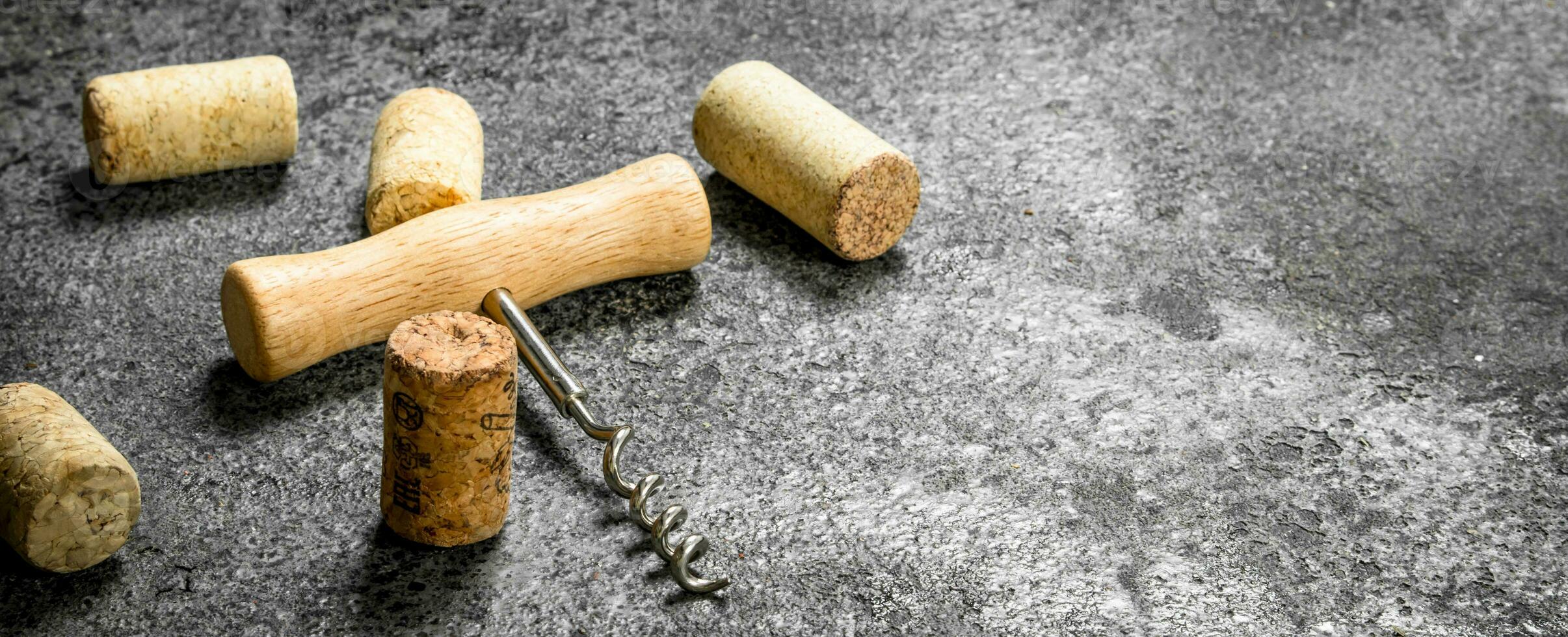 Corkscrew with wine corks. photo