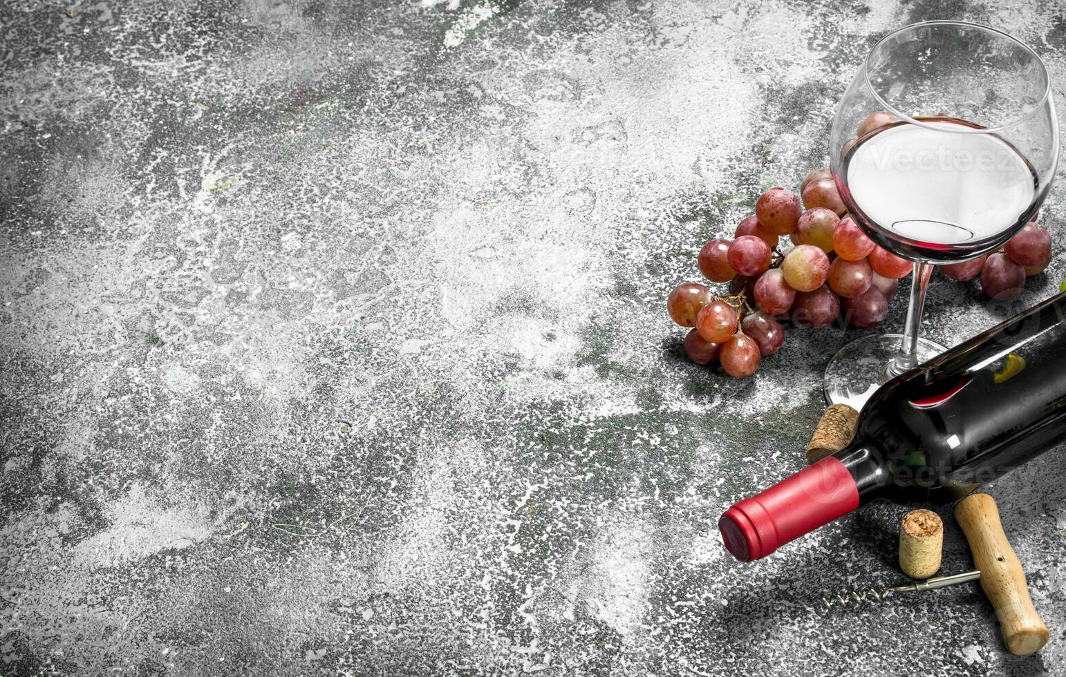 Red wine with a corkscrew. photo
