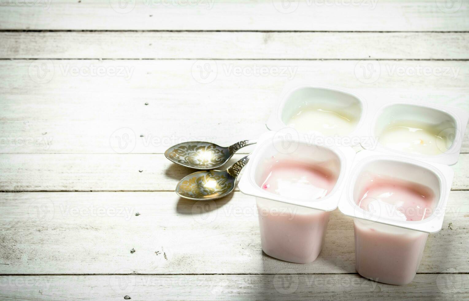 Fruit yogurt with spoons. photo