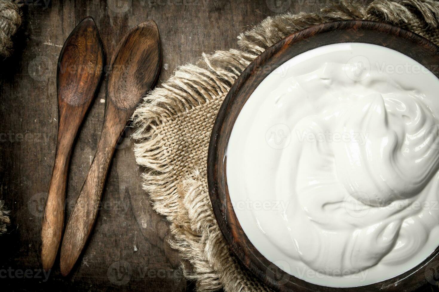Natural yogurt in a bowl. photo