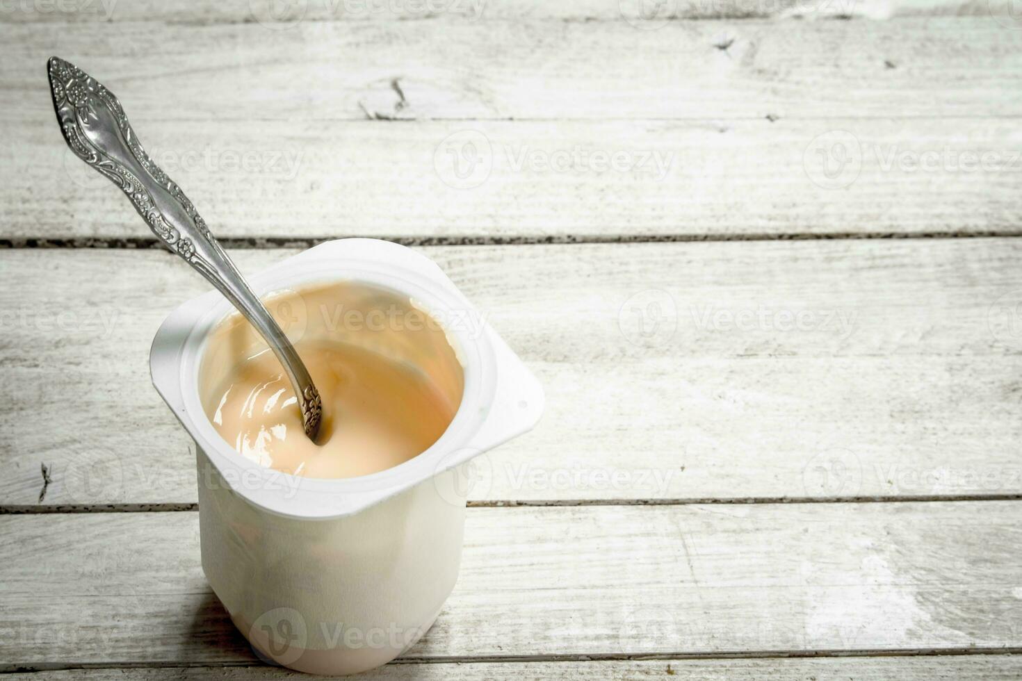 Fruit yogurt with spoons. photo