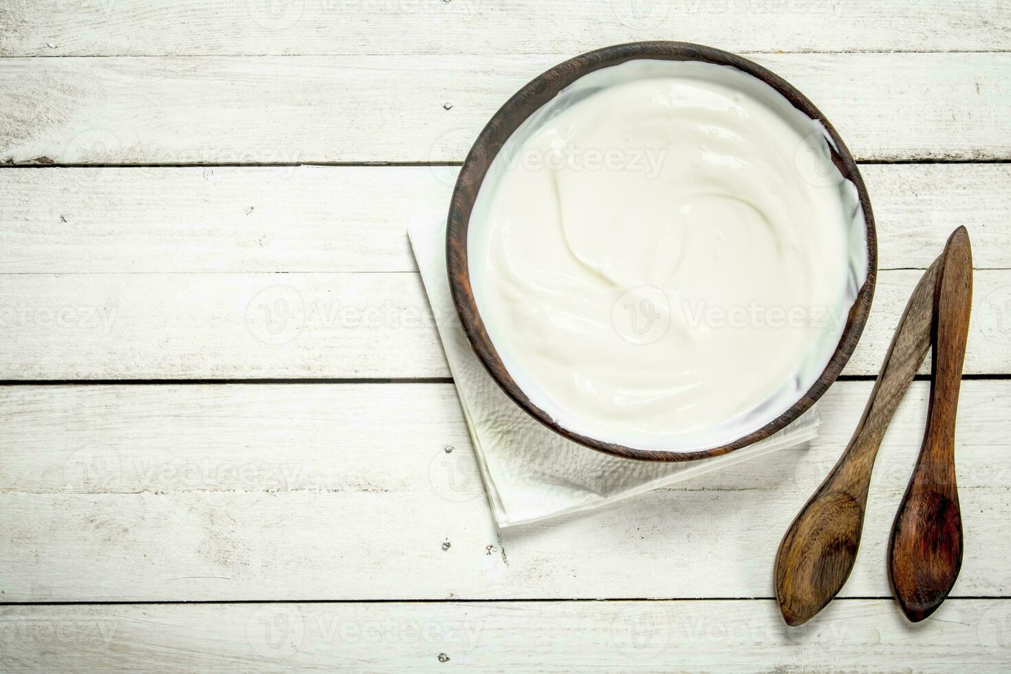 Natural yogurt in a bowl. photo