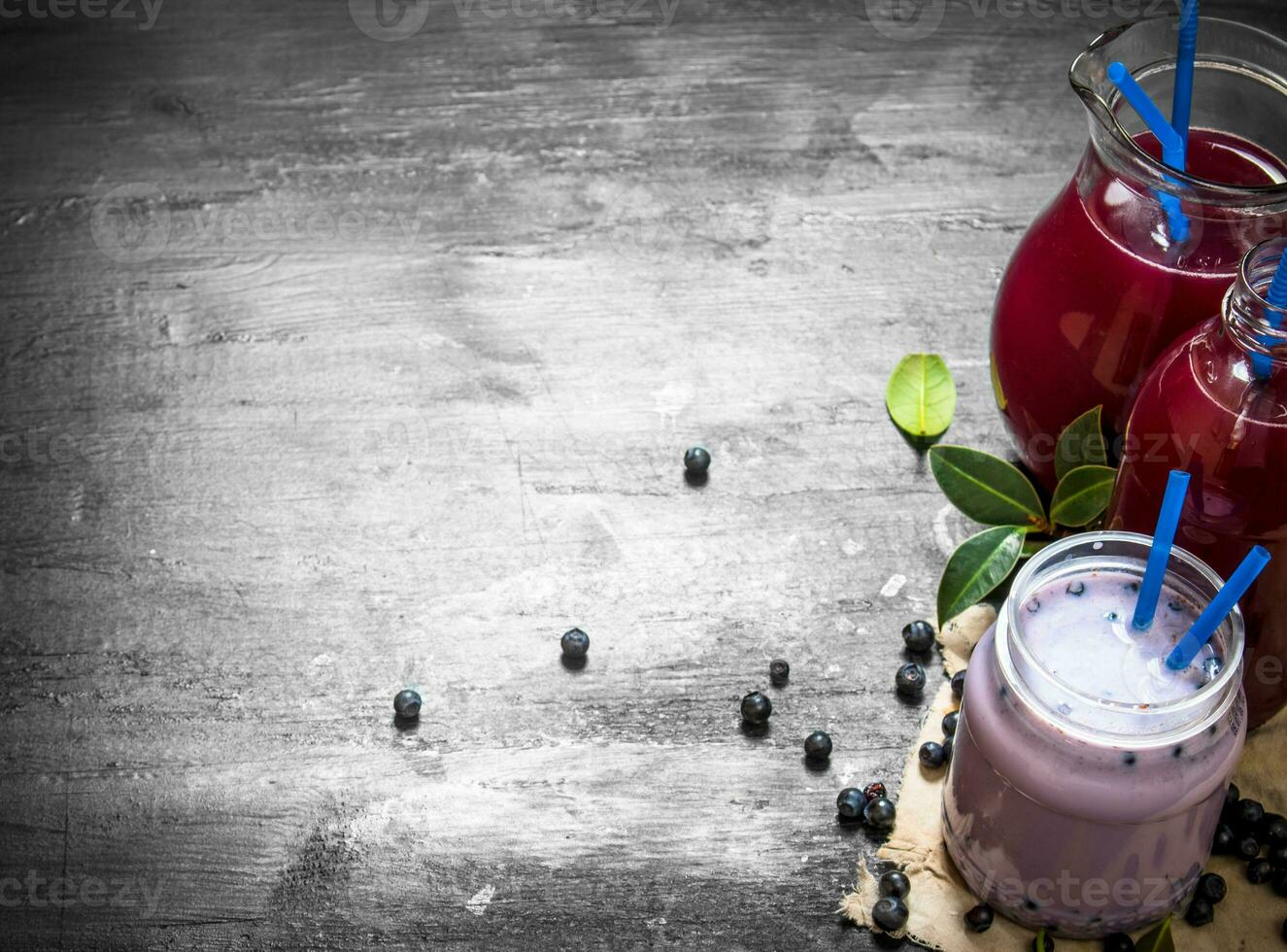 Blueberry smoothies and fresh juice on the old fabric. photo