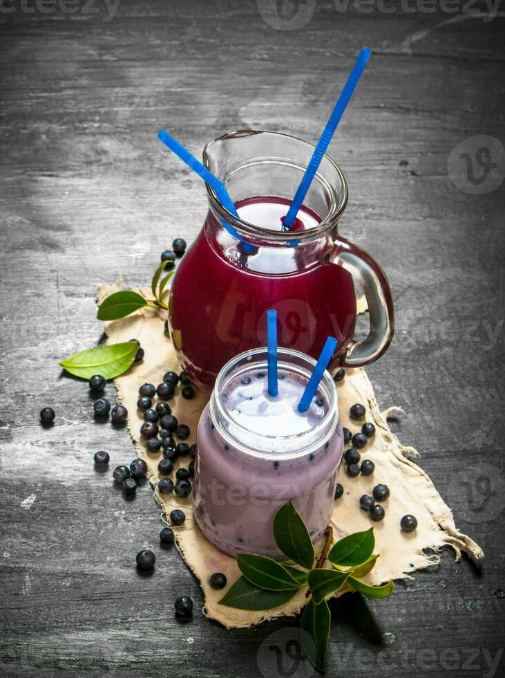 Blueberry smoothies and fresh juice on the old fabric. photo