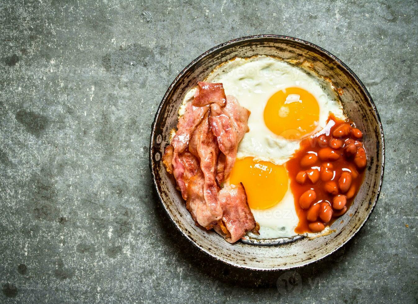 fresh Breakfast. Fried bacon with eggs and red beans. photo
