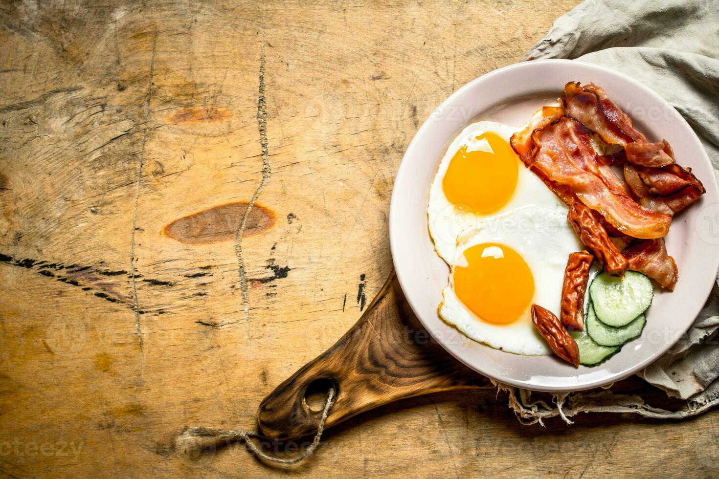 fresh Breakfast plate. Fried eggs with bacon and tomatoes. photo