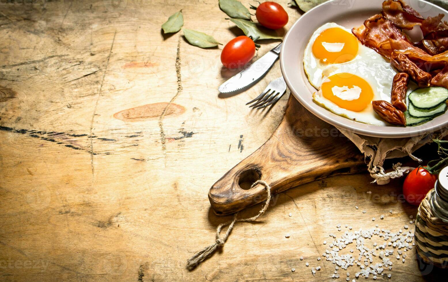 fresh Breakfast plate. Fried eggs with bacon and tomatoes. photo
