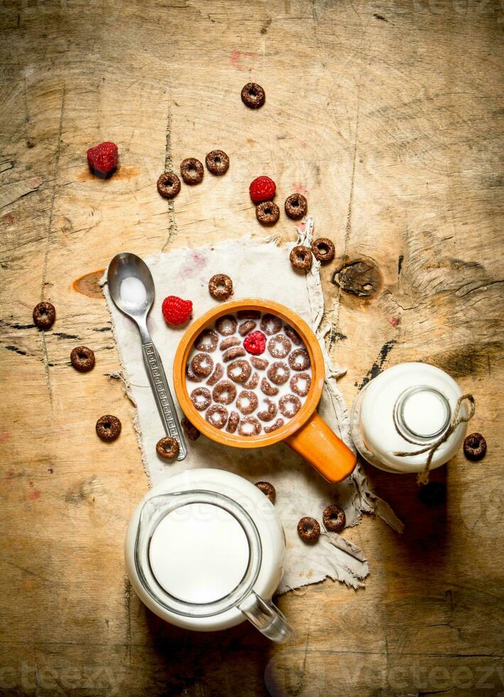 Healthy food. Chocolate cereal with raspberries and milk. photo