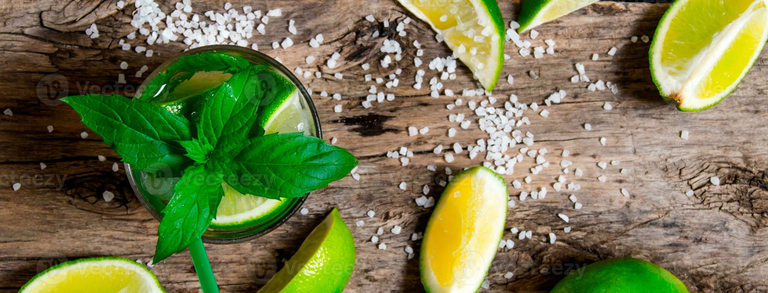 Freshly made mojito with mint and lime, sugar and rum. On a wooden table. photo