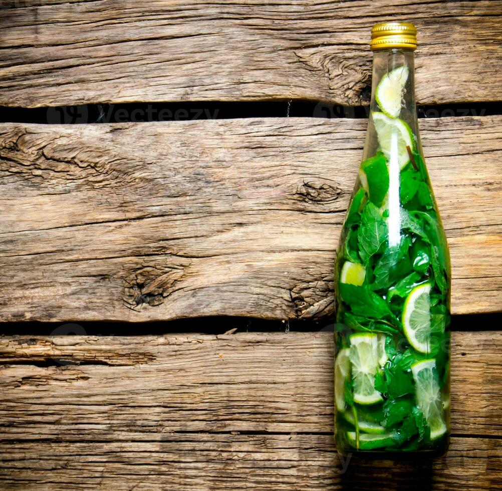 Cocktail bottle on a wooden table . Free space for text. photo